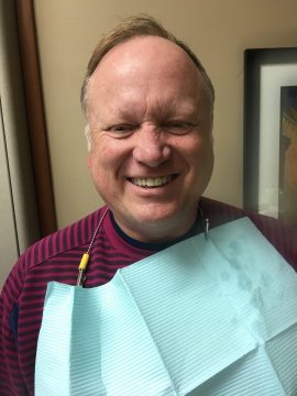 A man flashes a smile after having his dental implants installed